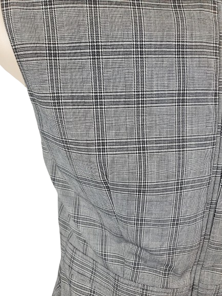 Close-up of a gray plaid patterned fabric on a mannequin.