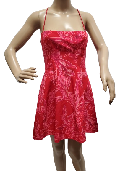 Red dress with white floral pattern on a mannequin against a white background