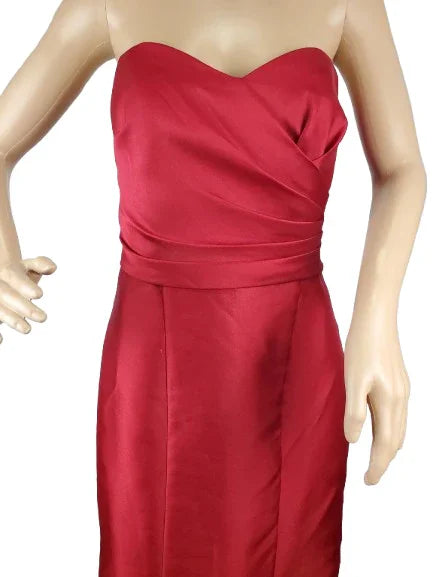 Red strapless dress on a mannequin against a white background