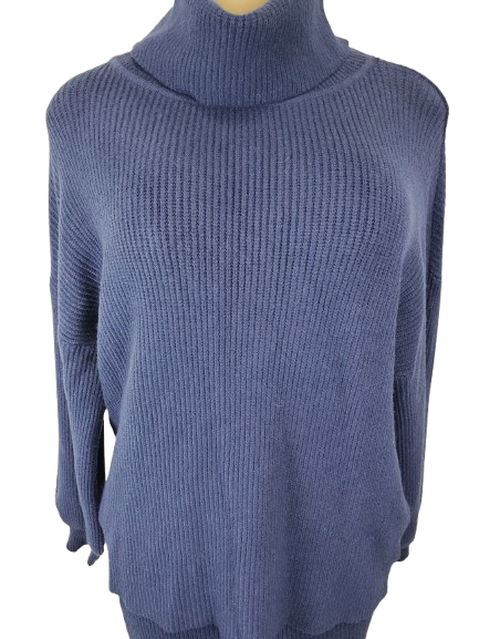 Blue ribbed sweater on a mannequin against a white background