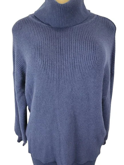 Blue ribbed sweater on a mannequin against a white background