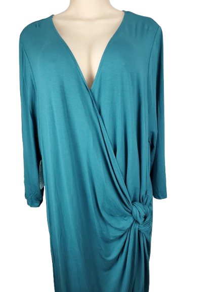 Teal dress with a deep neckline and knot detail on a mannequin against a white background