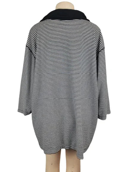 Black and white striped dress on a mannequin against a white background