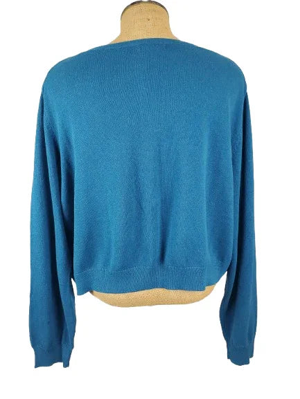 Blue sweater on a mannequin against a white background
