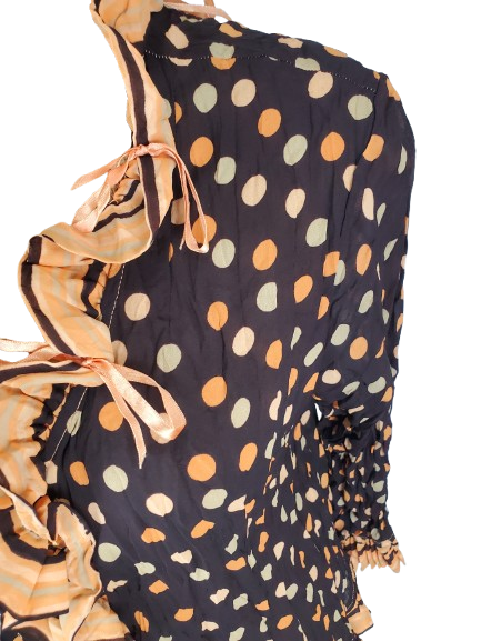brown top with colorful polka dot pattern and ruffled sleeves on a white background