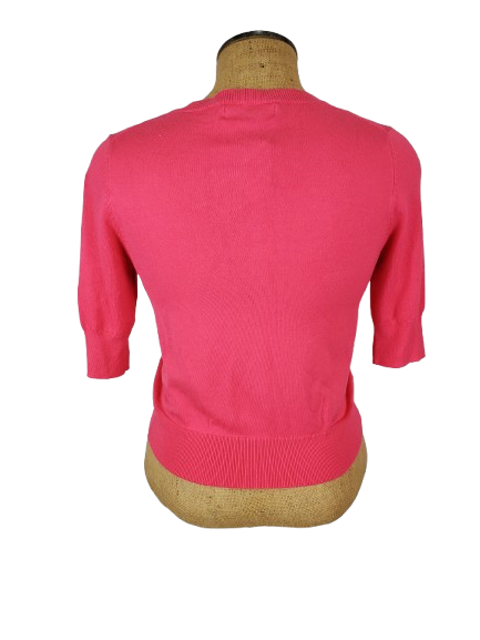 Pink women’s button front short sleeve cardigan sweater displayed on mannequin.