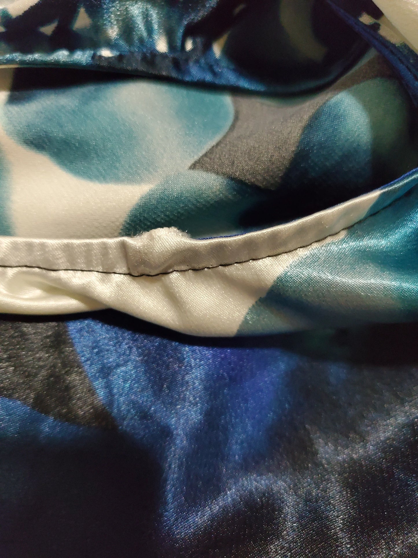 Close-up of blue and gray fabric with a visible seam