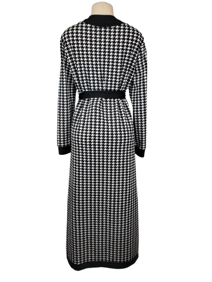 Black and white houndstooth patterned dress on a mannequin against a white background