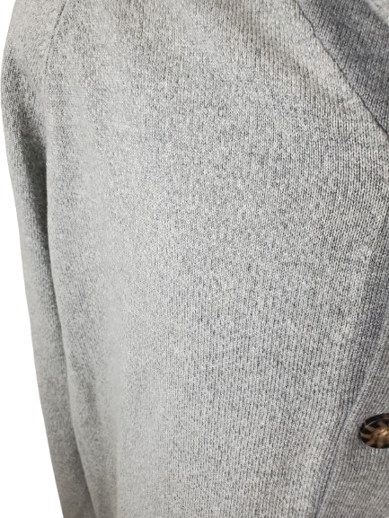 Close-up of a gray textured fabric with a button on a white background