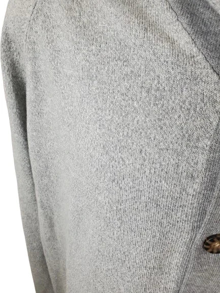 Close-up of a gray textured fabric with a button on a white background