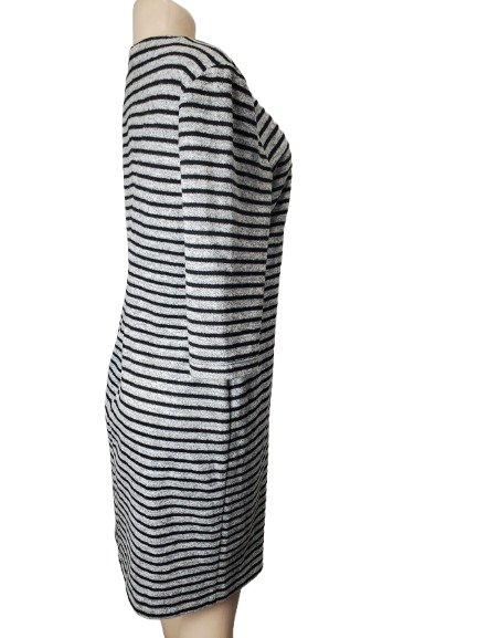 Mannequin wearing a black and gray striped dress on a white background