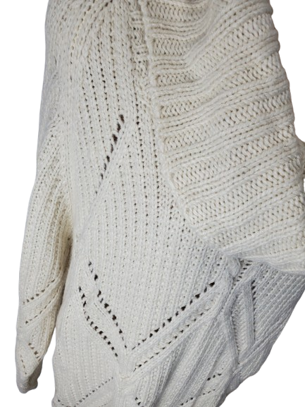 Close-up of a white knitted sweater with a geometric pattern on a white background