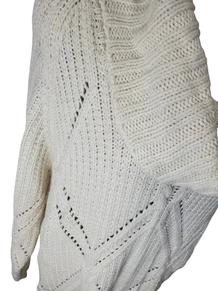 Close-up of a white knitted sweater with a geometric pattern on a white background
