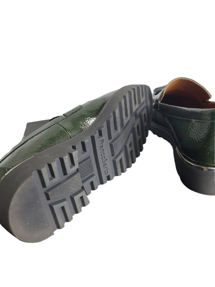 Green shoe with a focus on the sole on a white background