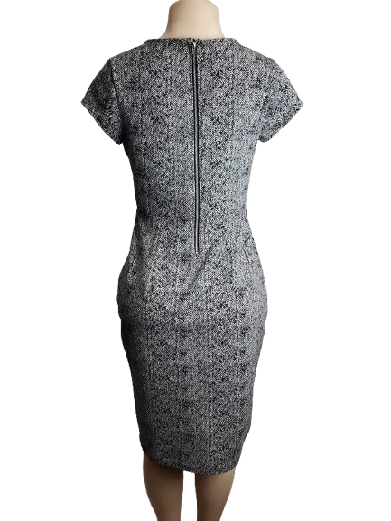 Black and white patterned dress on a mannequin against a white background