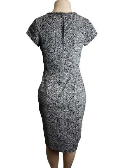 Black and white patterned dress on a mannequin against a white background