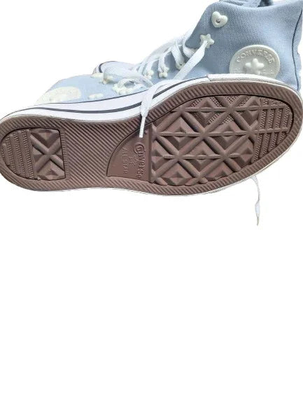 Light blue high-top sneaker with brown sole on a white background