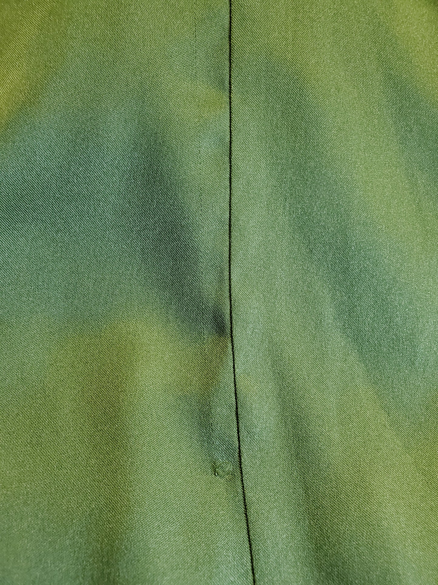 Close-up of green fabric with a visible seam