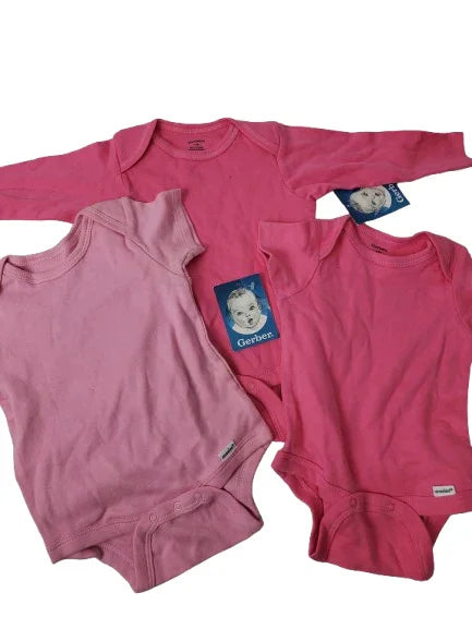 Three pink baby onesies with brand labels on a white background