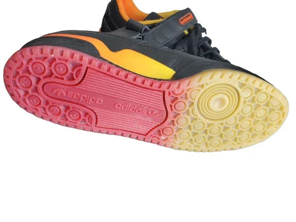 Close-up of a sneaker with a colorful sole on a white background