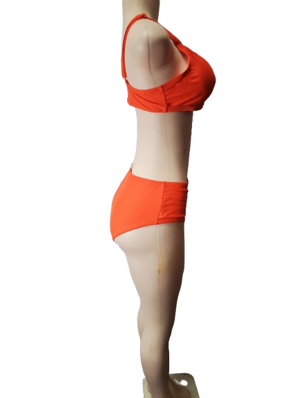 Mannequin wearing an orange bikini set on a white background