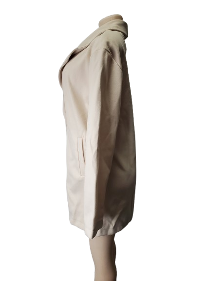 Beige coat on a mannequin against a white background