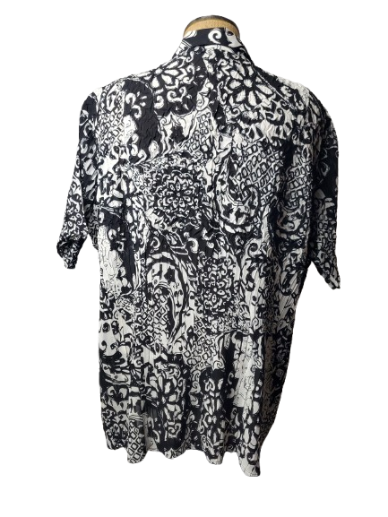 Black and white patterned shirt on a mannequin against a white background