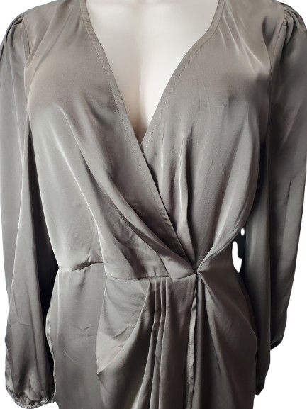 brown long-sleeve top on a mannequin with a plain background