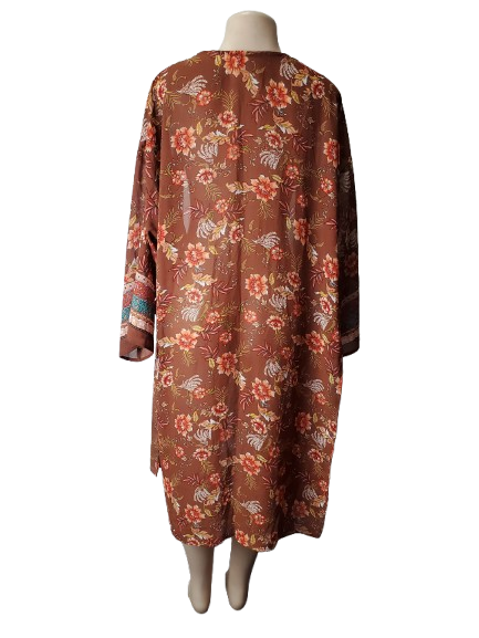 Floral patterned dress on a mannequin against a white background