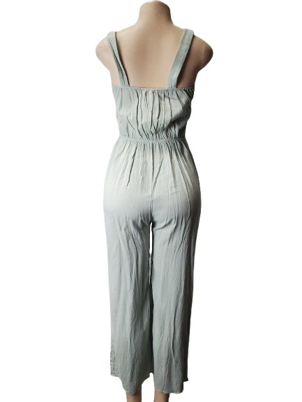 Light green jumpsuit on a mannequin against a white background