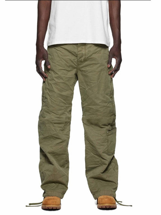 Person wearing green cargo pants and white shirt on a white background