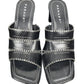 Pair of black sandals with white stitching on a white background, branded 'Parade'.