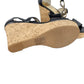 Black wedge sandals with cork sole on a white background