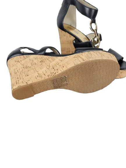 Black wedge sandals with cork sole on a white background