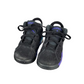 Pair of black sneakers with purple accents on a white background