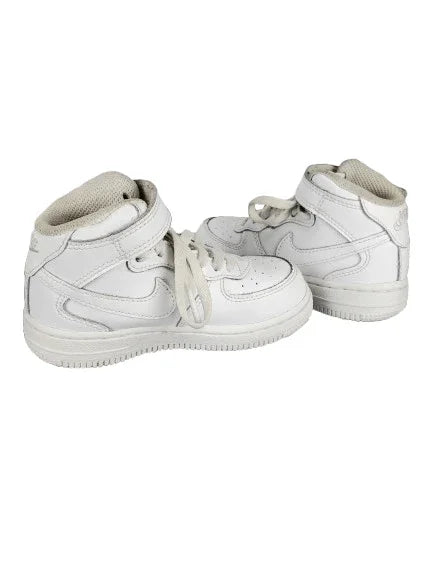 White sneakers with a Nike logo on a white background