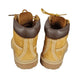 Pair of tan boots with brown tops on a white background