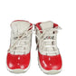 Pair of red and white sneakers on a white background