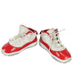 Pair of red and white sneakers on a white background