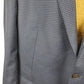 Gray checkered blazer with a button, close-up view