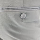 Close-up of a button on a gray fabric surface