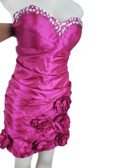 Pink strapless dress with floral details on a white background