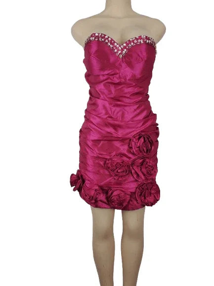 Pink strapless dress with floral details on a mannequin against a white background