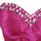 Close-up of a pink dress with silver embellishments on a white background