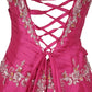 Pink dress with intricate lace-up back and embellishments on a white background