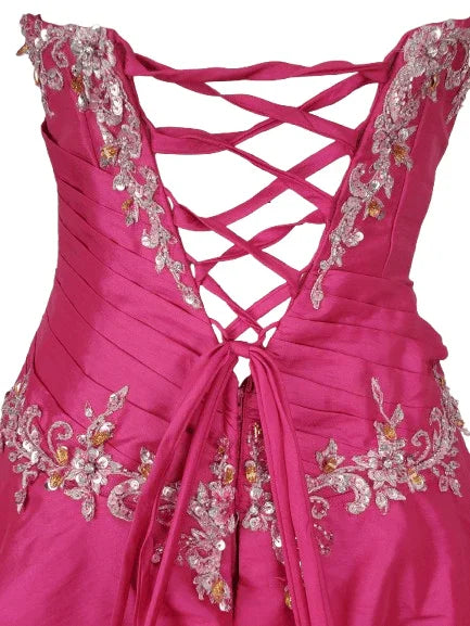 Pink dress with intricate lace-up back and embellishments on a white background