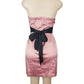 Pink strapless dress with a black belt on a mannequin against a white background