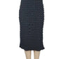 Black textured skirt on a mannequin against a white background