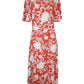 Coral and white floral dress on a mannequin against a white background