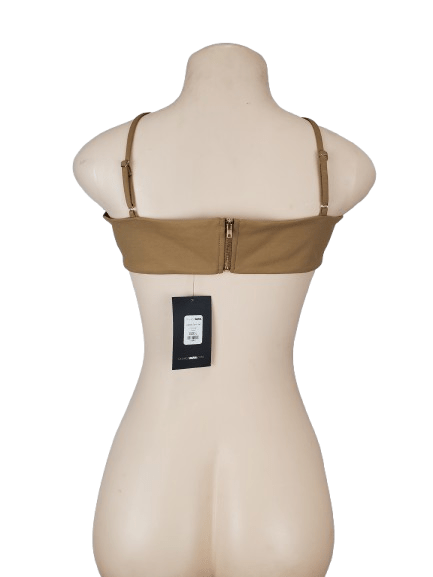 Brown bra on a mannequin with a tag against a white background